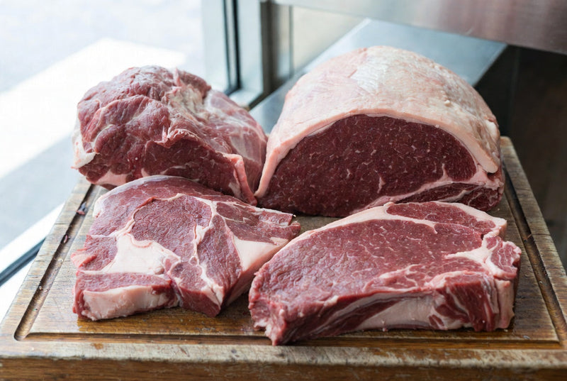 Selection of raw beef cuts commonly used for jerky including eye of round, bottom round, and flank steak