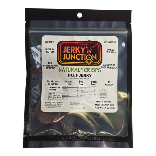 Jerky Junction Natural Crisps beef jerky front, black bag with window showing dark reddish-brown beef crisps and label badges