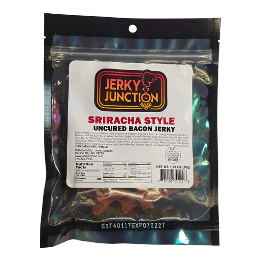 Jerky Junction Sriracha Style Uncured Bacon Jerky front, black bag with clear window showing reddish-brown bacon pieces