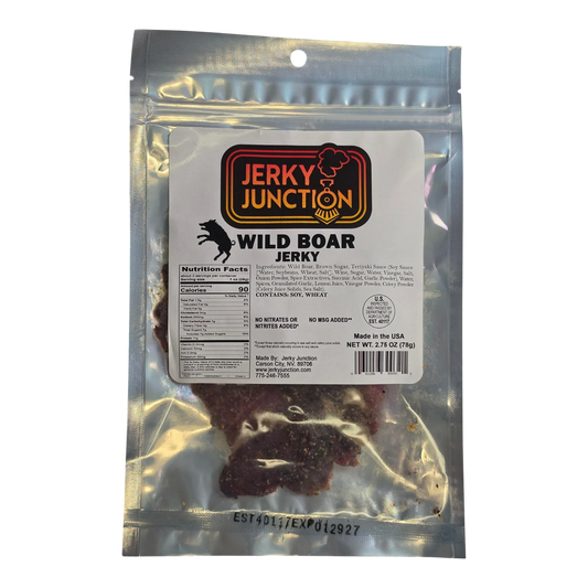 Jerky Junction Wild Boar Jerky front, clear bag with white label and dark reddish-brown spiced jerky pieces showing below