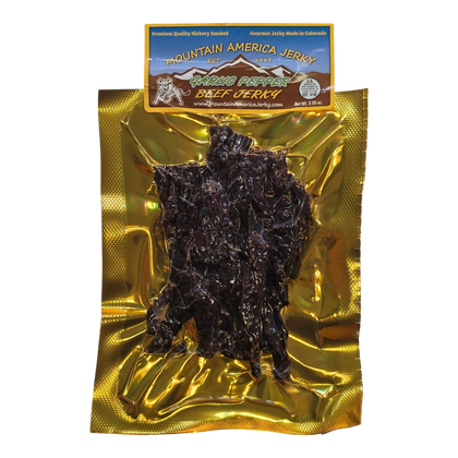 Mountain America Jerky Garlic Pepper Beef Jerky front: gold bag with a window showing dark strips flecked with pepper