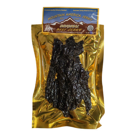 Mountain America Jerky Original Beef Jerky front, gold bag with dark beef strips visible through the window