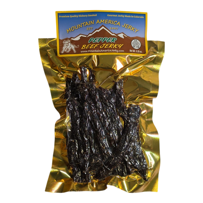 Mountain America Jerky Peppered Beef Jerky front: gold bag, mountain and bull label, window showing dark spiced strips