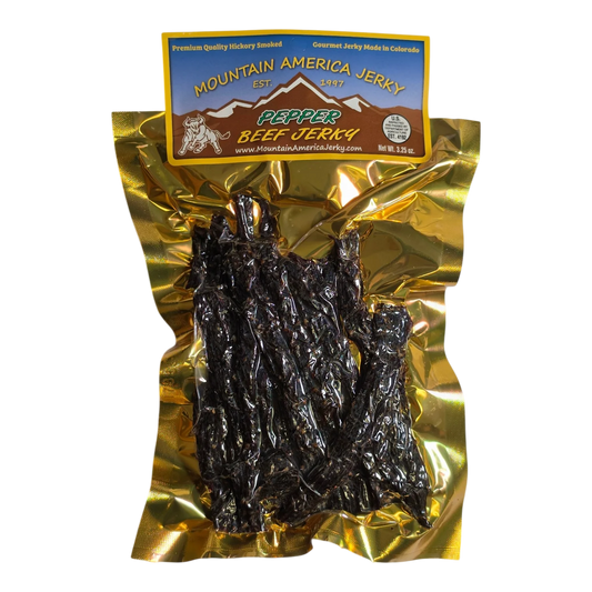 Mountain America Jerky Peppered Beef Jerky front: gold bag, mountain and bull label, window showing dark spiced strips