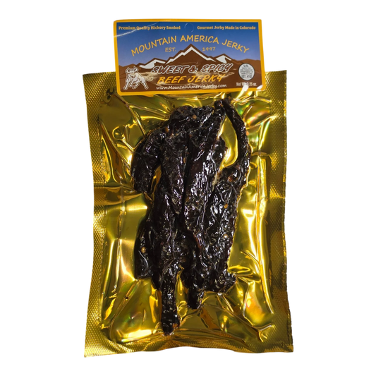 Mountain America Jerky Sweet & Spicy Beef Jerky front, gold vacuum pack with dark glossy beef strips visible