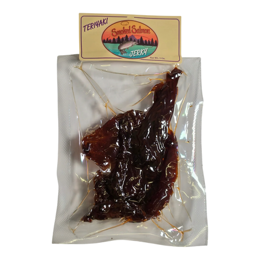 Mountain America Jerky Teriyaki Salmon Jerky front: clear vacuum-sealed pack with dark, glossy salmon pieces visible