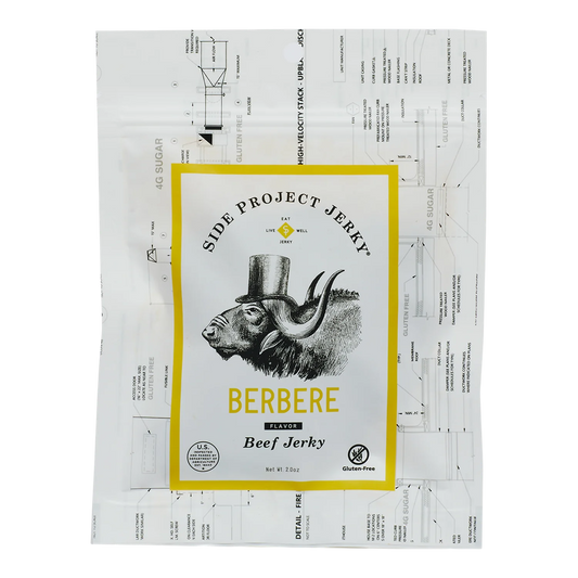 Side Project Jerky Berbere Flavor Beef Jerky bag front, yellow-bordered label, top-hat buffalo, Gluten-Free badge