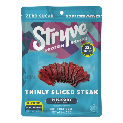Stryve Hickory Seasoned Thinly Sliced Steak front of bag: fanned dark red air-dried beef slices and a 32g protein badge